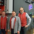 Markus Hargassner, Anton Hargassner jr. und Anton Hofer (v. l.) vor dem neuen Hackschnitzel-Industrieheizkessel Magno, der mit dem EnergieGenie 2022 ausgezeichnet wurde.
