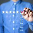Businessman putting check mark a checkbox on five star rating. Increase rating company or ranking, evaluation and review concepts