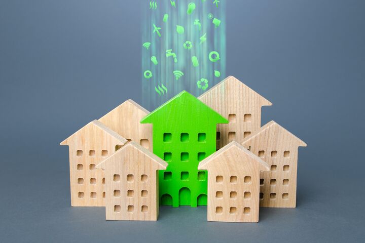 Green building stands out among the houses. Renovation and environmental improvement of old buildings. Net Zero Carbon neutrality. Environmentally friendly, energy efficient and zero emissions.
