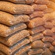 1 ton of wooden pellets packed in 15kg bags. Wooden pellets stacked in plastic bags. Heating fuel is delivered to the household to heat interiors in winter. Sustainable future concept.