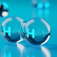 Abstract transparent hydrogen H2 molecules on blue background, clean energy or chemistry concept, 3D illustration