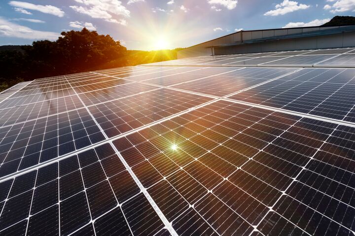 Solar panels on factory roof photovoltaic solar panels absorb sunlight as a source of energy to generate electricity creating sustainable energy.
