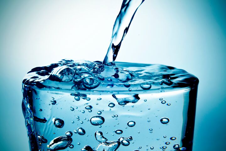 closeup of a refreshing glass of water which is being filled