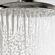 Water droplets falling from a metal shower head.