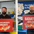 Fachmänner von ÖAG und SHT, die auf die Serviceleistungen der Großhändler und das Gewinnspiel hinweisen.