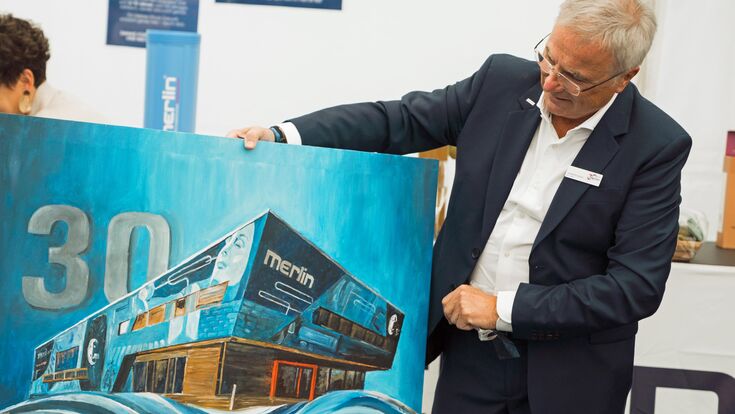 Gründer und CEO Johann Reisinger mit Kunstwerk zum 30-Jahr-Jubiläum von Merlin Technology